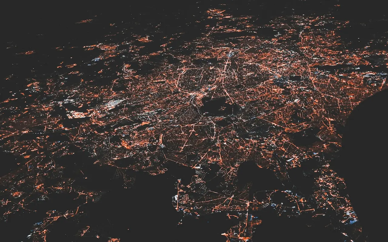 Network of city lights viewed from above, representing the interconnected nature of modern digital infrastructure