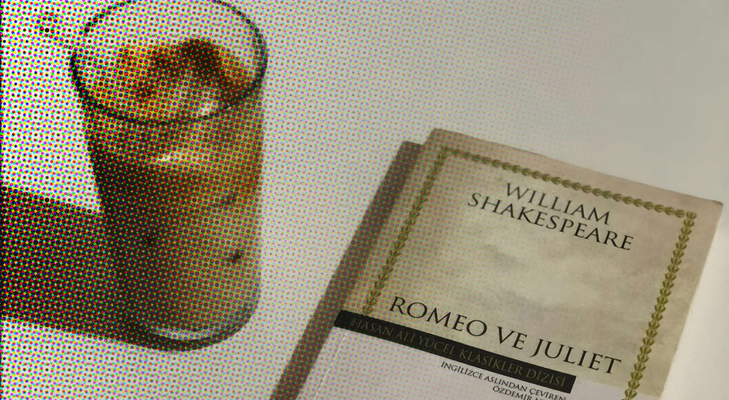 Book of Romeo and Juliet set next to an iced coffee